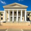 Exterior view of the Supreme Court of Florida with columns and palm trees