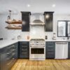 Modern kitchen with black cabinets and stainless appliances.