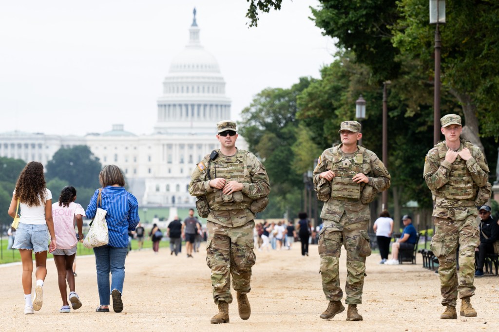 Members of the National Guard patrol near the US Capitol on the National Mall near the US Capitol in Washington, DC, on August 20, 2025.