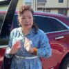 Winnie Greco standing by her car.