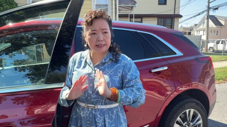 Winnie Greco standing by her car.
