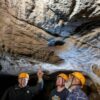 Mal and Dylan Siely examine finger grooves at Waribruk with GunaiKurnai Elder Uncle Russell Mullett