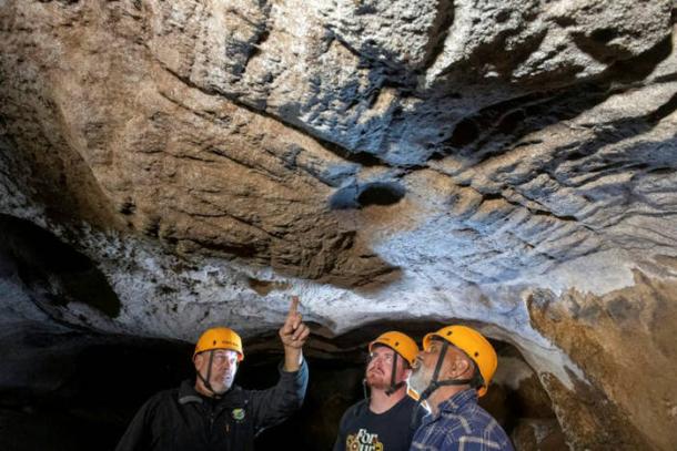 Mal and Dylan Siely examine finger grooves at Waribruk with GunaiKurnai Elder Uncle Russell Mullett