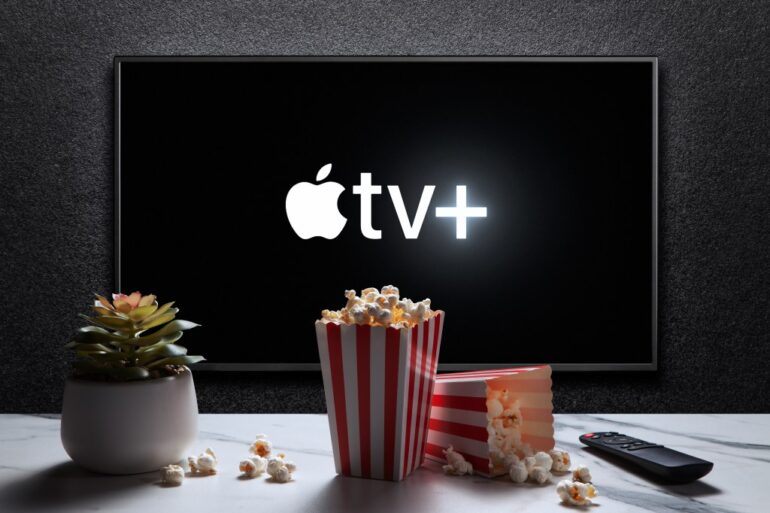 Apple TV+ logo on a TV screen, with popcorn and a remote.