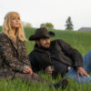 Beth Dutton and Rip Wheeler sitting on the grass