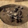 Sacrificial pit of the Salzmünde Culture at Gerstewitz, containing dog bones, a human skull, charred house wall remains, and a horn core.