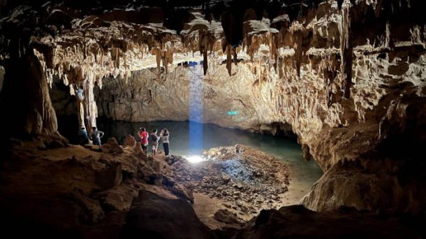 Tourists explore the 'Dome of the Cathedral', the largest chamber in Grutas Tzabnah, Yucatán, Mexico