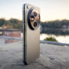 OnePlus Open folded shut on a pedestal with sunrise behind