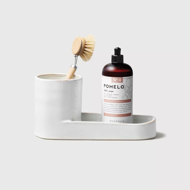 The caddy has a cylindrical storage area and an attached tray for bottles, sponges and more.