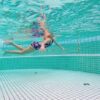 The more organic matter in the pool, the more chloramines are produced (that includes pee, along with sweat and poop particles).