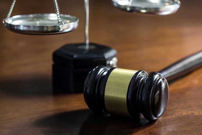 Gavel and scales of justice on wooden table.