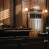 Empty courtroom with judges bench and wooden decor.