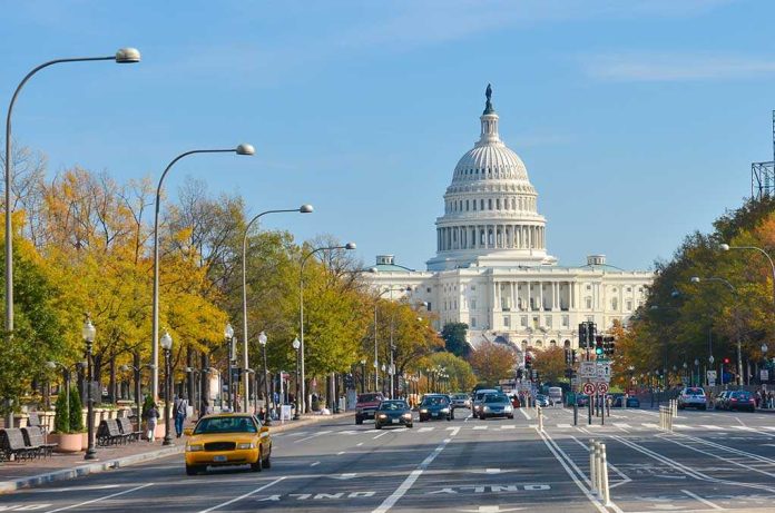 View of the Capitol building in Washington D.C. with autumn trees lining the street