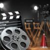 Film production equipment including a clapperboard, film reel, and directors chair