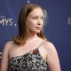 Hannah Einbinder at the Emmy Awards wearing a red hand pin.
