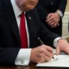 US President Donald Trump signs an executive order with small business leaders in the Oval Office at the White House in Washington, DC on January 30, 2017. / AFP PHOTO / NICHOLAS KAMM (Photo credit should read NICHOLAS KAMM/AFP via Getty Images)