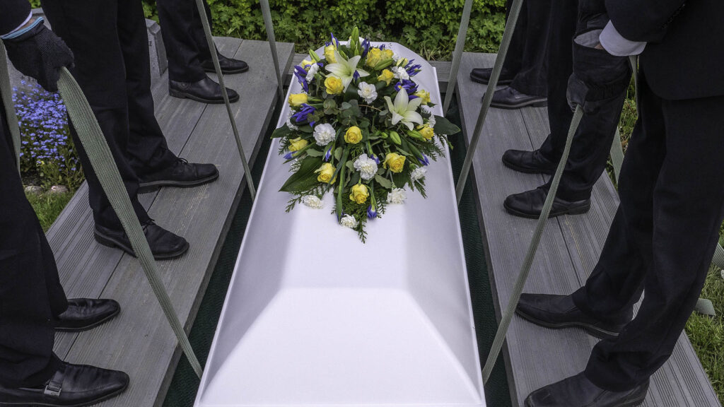 Satire news: mourners unaware they burying knockoff giorgio armani