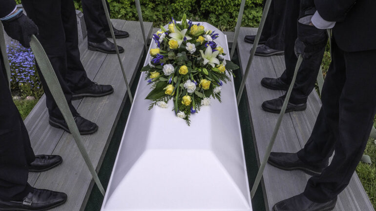 Satire news: mourners unaware they burying knockoff giorgio armani