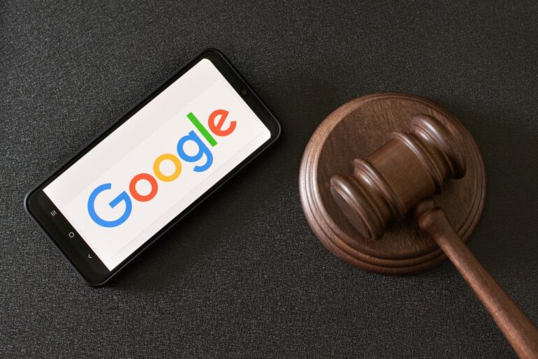 Smartphone displaying the Google logo next to a judge's gavel.