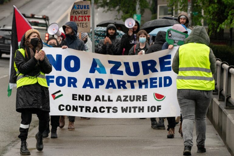 Demonstrators holding a banner that reads "NO AZURE FOR APARTHEID END ALL AZURE CONTRACTS WITH IOF" during a rally in Seattle.