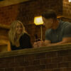 Emilia Harcourt smiling at Chris Smith at night in Peacemaker season 2