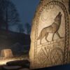 Ancient Norse rune stone carving showing wolf figures
