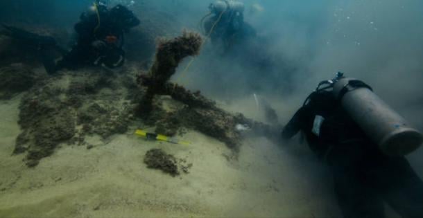 Divers exploring the submerged ancient structures off the coast of Taposiris Magna