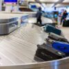 Luggage on a conveyor belt at an airport baggage claim area