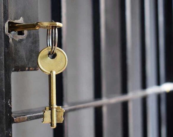 Key in lock of prison cell door.