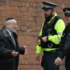 Police officers talk with a member of the local community near Heaton Park Hebrew Congregation synagogue in Crumpsall, north Manchester, on October 2, 2025, following an attack at the synagogue. Two people were killed and three wounded in a car ramming and stabbing incident outside a synagogue in Manchester, northwest England, on Thursday, police said. "A man believed to be the offender was shot by GMP (Greater Manchester Police) Firearms Officers and is also believed to be deceased," the force said on X, adding his death could not yet be confirmed due to "suspicious items on his person". (Photo by Oli SCARFF / AFP) (Photo by OLI SCARFF/AFP via Getty Images)