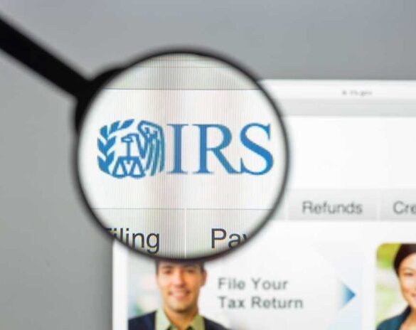 Magnifying glass over IRS website.