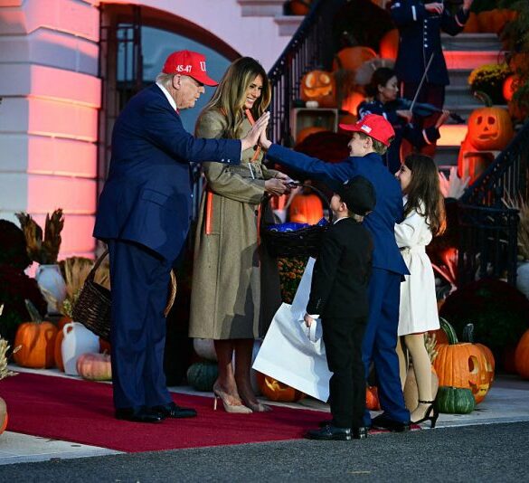 US President Donald Trump high-fives a boy as he and First Lady Melania Trump host a Halloween event at the White House in Washington, DC, on OCtober 30, 2025. (Photo by Jim WATSON / AFP) (Photo by JIM WATSON/AFP via Getty Images)