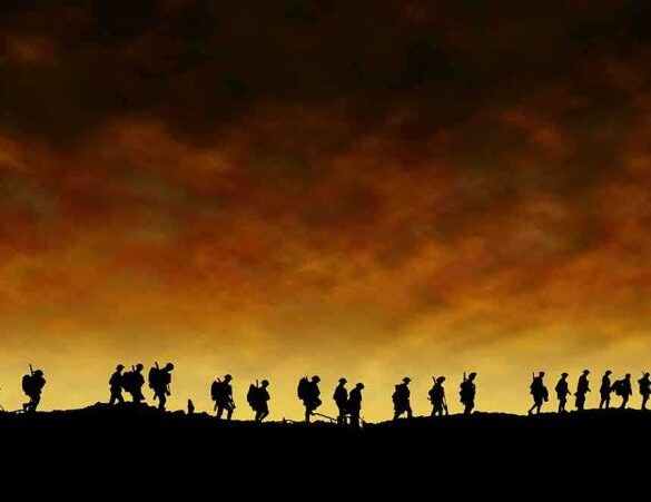 Silhouetted figures walking against a sunset backdrop