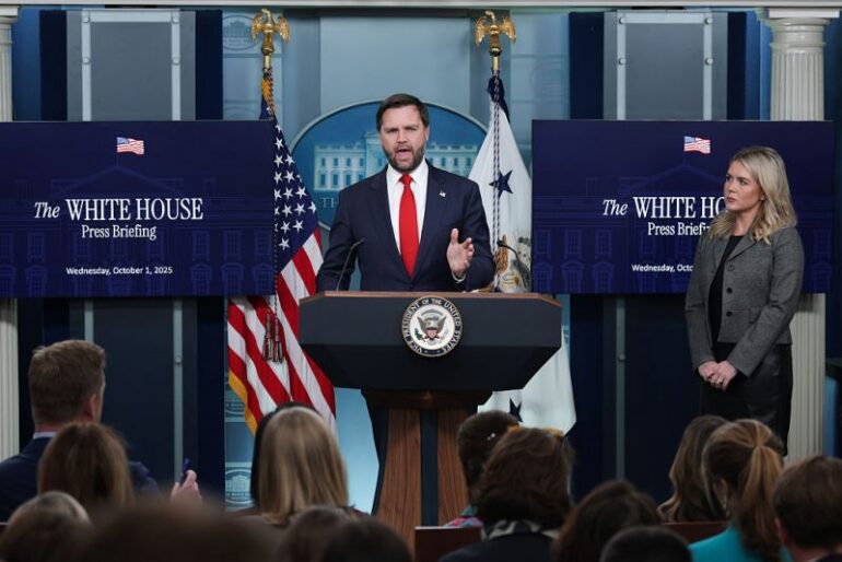 WASHINGTON, DC - OCTOBER 01: U.S. Vice President JD Vance speaks as White House Press Secretary Karoline Leavitt (R) looks on during the daily press briefing in the Brady Press Briefing Room at the White House on October 01, 2025 in Washington, DC. Vance joined Leavitt to discuss the federal government shutdown, after Congress and the White House failed to reach a funding deal by the October 1 deadline and halted U.S. government services for the first time in nearly seven years. (Photo by Alex Wong/Getty Images)