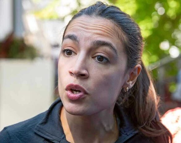 Woman speaking with a concerned expression outdoors.