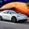 Tesla Model Y Standard car driving on a road.