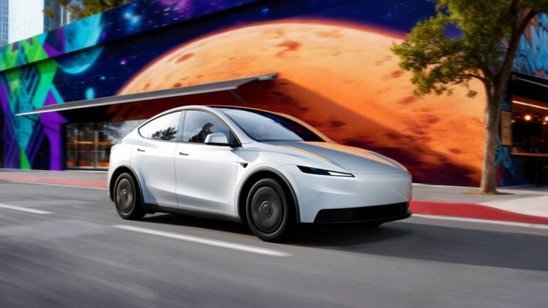 Tesla Model Y Standard car driving on a road.