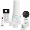 A collection of SimpliSafe smart home security system components, including a keypad, base station, indoor camera, outdoor camera, entry sensors, and motion sensors.