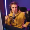 Pro gamer recording video live stream while playing computer games