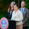 Patty Salazar, front, executive director of Colorado Department of Regulatory Agencies, speaks on May 24, 2024, during a ceremony outside the governor's mansion in downtown Denver.
