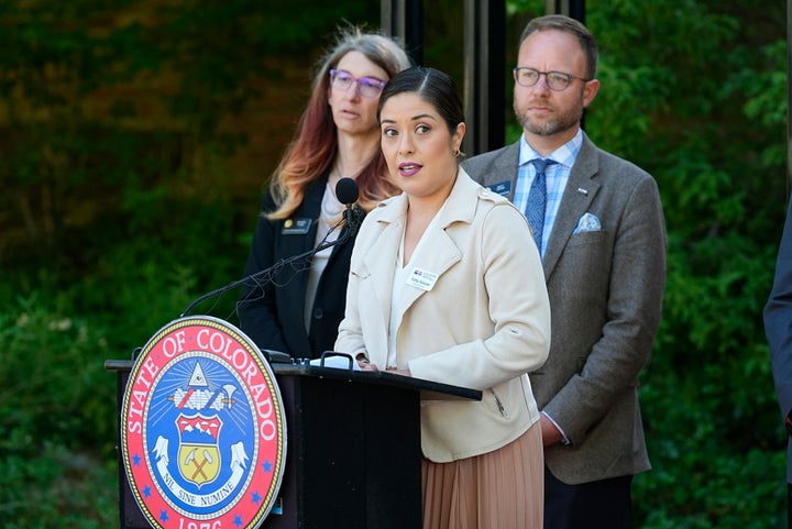 Patty Salazar, front, executive director of Colorado Department of Regulatory Agencies, speaks on May 24, 2024, during a ceremony outside the governor's mansion in downtown Denver.