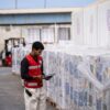 A member of the Egyptian Red Crescent takes stock at the aid warehouse in Al-Arish, near the Rafah crossing between Egypt and Gaza, on Oct. 9, 2025.