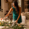 Meghan Markle setting a Christmas-decorated table.
