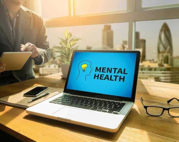 Laptop displaying Mental Health screen in an office.