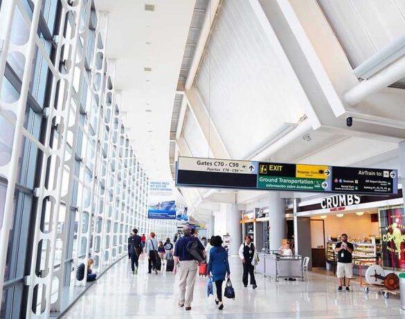 People walking in a brightly lit airport terminal.