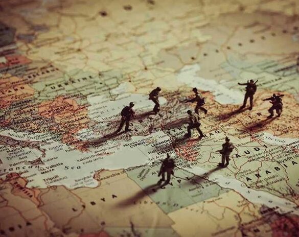 Toy soldiers on a world map background.