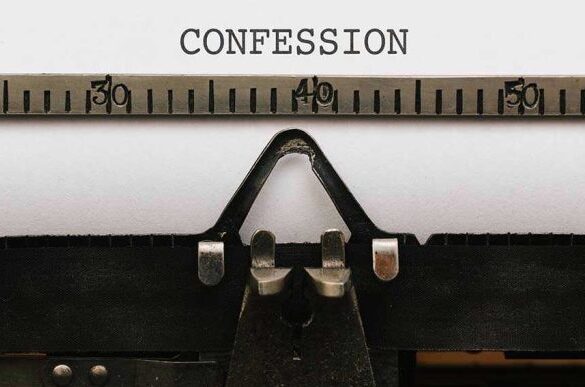 Typewriter typing the word confession on paper