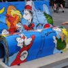 A colorful bench featuring Dr. Seuss characters with a child playing nearby