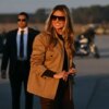 US First Lady Melania Trump smiles as she boards the plane to depart from Albert J. Ellis Airport in Jacksonville, North Carolina, November 19, 2025. First Lady Melania Trump and Second Lady Usha Vance are returning to Washington after visiting military families at Marine Corps Air Station New River in Jacksonville, North Carolina. (Photo by SAUL LOEB / AFP) (Photo by SAUL LOEB/AFP via Getty Images)
