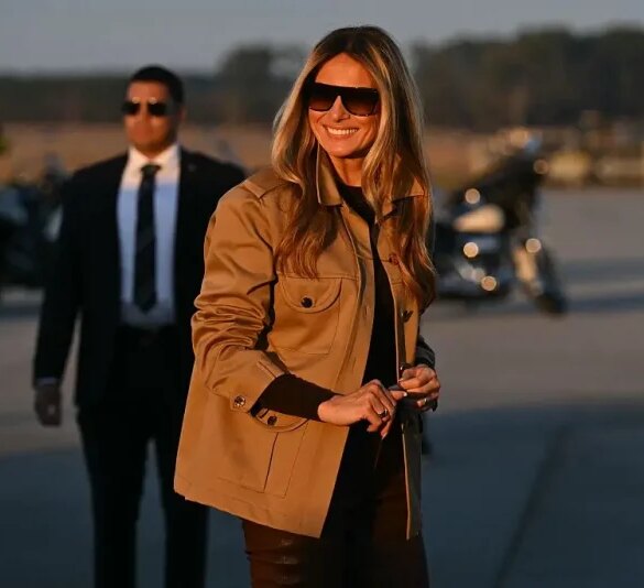 US First Lady Melania Trump smiles as she boards the plane to depart from Albert J. Ellis Airport in Jacksonville, North Carolina, November 19, 2025. First Lady Melania Trump and Second Lady Usha Vance are returning to Washington after visiting military families at Marine Corps Air Station New River in Jacksonville, North Carolina. (Photo by SAUL LOEB / AFP) (Photo by SAUL LOEB/AFP via Getty Images)